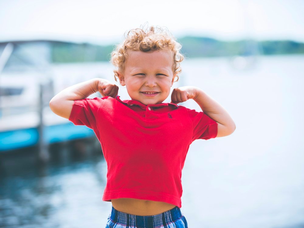 Smiling child in a red shirt